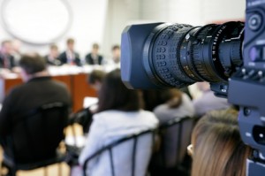 TV camera at press conference.